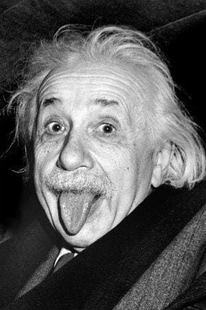 a black and white photograph of the famous Einstein sticking his tongue out.